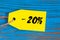 Sale minus 20 percent. Big sales twenty percents on blue wooden background for flyer, poster, shopping, sign, discount