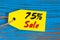 Sale minus 75 percent. Big sales seventy five percents on blue wooden background for flyer, poster, shopping, sign