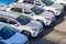 Sale of new cars in a car dealership. Row of white unmarked cars