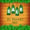 Sale poster of Saint Patrick`s day with shamrock on wooden background and hanging green tags. Vector illustration