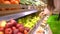 Sale, shopping, food, consumerism and people concept - woman with bag buying apples at grocery store