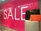 Sale Sign and handbags on display in shop front window