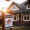 For Sale sign sits outside a suburban residential house