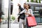 Sale, travel love consumerism and people concept. Happy couple with shopping bags in the city