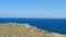 Salento countryside panoramic view panning watchtower coastal seascape grass Apulia Italy