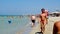 Salento holiday makers walk shore Torre San Giovanni beach crystalline waters Ionian sea