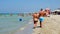 Salento holiday makers walk shore Torre San Giovanni beach crystalline waters Ionian sea