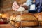 Sales Assistant In Bakery Putting Blank Label Into Freshly Baked Sourdough Loaves Of Bread