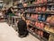 Sales assistant staff workers filling shop shelves with snacks crips ready for sale to customers