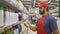 Sales clerk in red uniform scanning cleaners barcode in supermarket