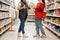 The sales consultant communicates with the buyer. Two young Caucasian women. Close up. Concept of shopping, business and trade