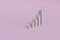 sales growth chart. graph of volumetric arrows on a pink pastel background. 3D render