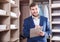 Sales manager with clipboard in dressing room