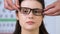 Sales manager wearing glasses on smiling womans face, eyewear fitting, size