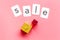 Sales message. Text Sale near gift boxes on pink background top-down copy space