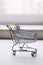 Sales and shopping sphere, empty shopping trolley on a light background, shopping basket, supermarket trolley