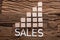 Sales Text By Increasing Bar Graph Blocks On Wood