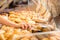 Sales woman in baker shop putting bread roll in paper bag