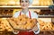 Sales woman offering fresh pastries