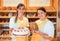 Sales women in bakery with cake and bread