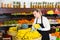 Salesgirl arranging goods in greengrocery