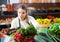 Salesgirl arranging greens