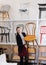 Salesgirl demonstrating wooden chairs in salon