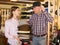 Salesgirl offering hats to man