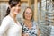 Salesgirl With Senior Woman In Optician Store