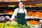 Salesgirl standing in greengrocery