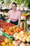 Salesgirl welcoming to vegetable store