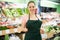 Salesgirl welcoming to vegetable store