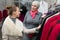 Saleslady showing Variety of Jackets to Customer in Retail Store