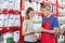 Salesman Assisting Customer In Buying Pet Food At Shop