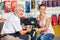 Salesman Assisting Woman In Hardware Store