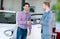 Salesman and client at the car saloon