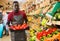 Salesman filling counter with red peppers