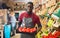 Salesman filling counter with red peppers