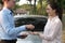 Salesman give car key to customer. woman buying car from dealer.