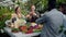 Salesman giving organic products to customers in greenhouse farm market