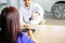 Salesman handing over car key to a customer woman