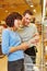 Salesman helping woman finding groceries