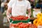 Salesman holding cherry tomato at street market