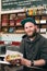 Salesman with hotdog in fast food snack bar