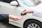 Salesman offering car key to a businessman from the car dealer.