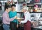 Salesman Offering Samples To Customers In Cheese Shop