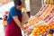 Salesman selecting fresh fruit and talking on the phone in fruitshop.