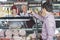 Salesman Serving Fresh Cheese To Customer In Shop