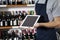 Salesman Showing Blank Digital Tablet In Wine Shop