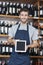 Salesman Showing Blank Digital Tablet In Wine Shop